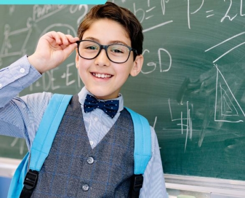 Tehetséggondozás gazdagító programokkal kiemelt kép. Egy kisfiú a szemüvegét igazítja meg a matematika képletekkel teleírt tábla előtt állva. A képen feltüntettük a képzés típusát: online
